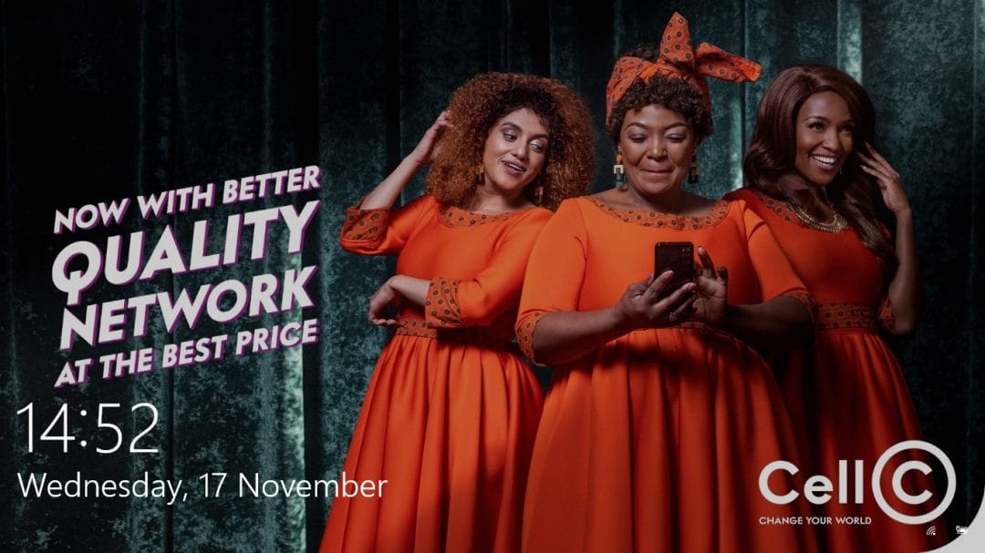 Three smiling women in matching bright orange dresses pose cheerfully. One holds a phone while the others gesture excitedly, showcasing the ease of a powerful corporate communications tool. Bold text reads, "QUALITY NETWORK." Cell C branding and a digital clock showing 14:52, Wednesday, 17 November, appear on the image.