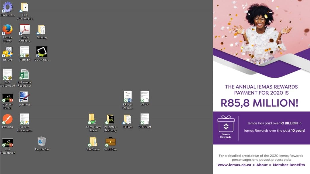 A computer desktop with several file and folder icons on the left. On the right, a banner shows a smiling woman, confetti, and text: "The annual Iemas Rewards payment for 2020 is R85,8 million!" with website and contact details below. The desktop display suggests the seamless integration of corporate communications software to keep employees informed of important announcements.