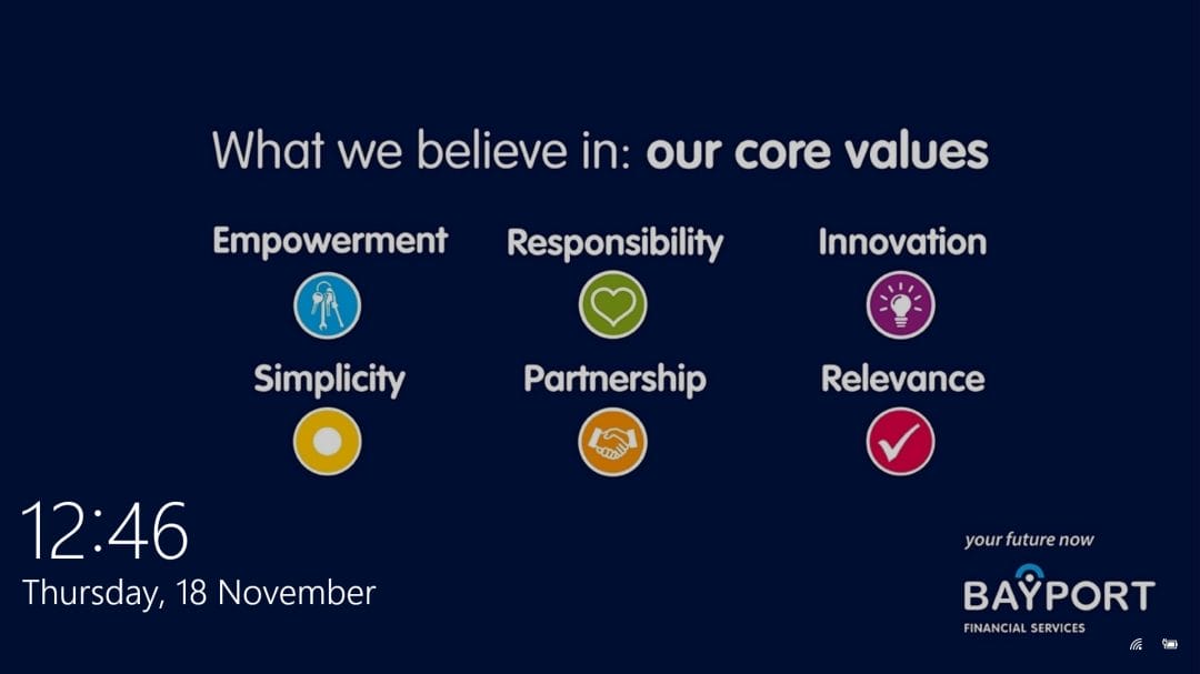 A navy slide lists Bayport’s core values: Empowerment, Simplicity, Responsibility, Partnership, Innovation, and Relevance, each with a colored icon. The time is 12:46 and the date is Thursday, 16 November. Bayport’s logo appears in the lower right corner, highlighting the effectiveness of their corporate communications tool in reinforcing key messages visually.