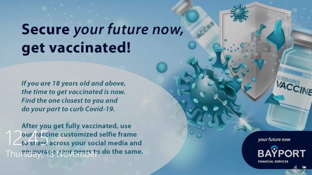 A COVID-19 vaccine ad features vials, a shield, and virus particles. Text encourages those 18+ to get vaccinated and share selfies to inspire others. Bayport Financial Services’ logo is visible, showcasing the power of effective corporate communications software in spreading important health messages. Date and time (12:12, Thursday 25 November) appear in the bottom left corner.