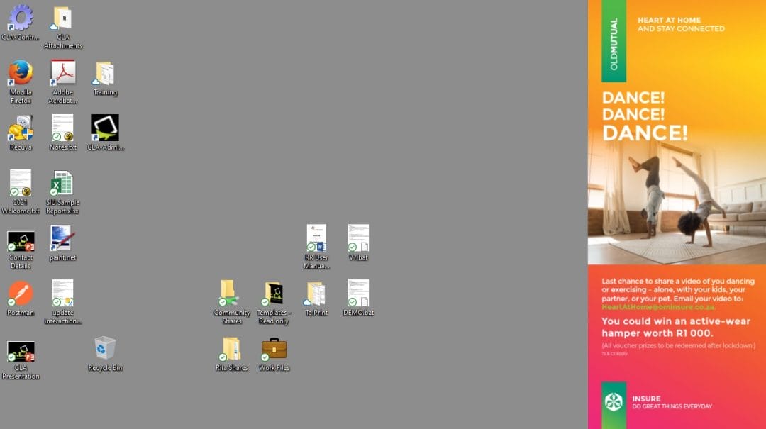 A computer desktop with icons on the left, grouped in clusters, showcases a streamlined workspace often enhanced by corporate communications software. The background is grey. On the right, there is a vertical banner ad showing a woman dancing in a bright living room. The ad promotes a dance contest to win a hamper worth R1,000.