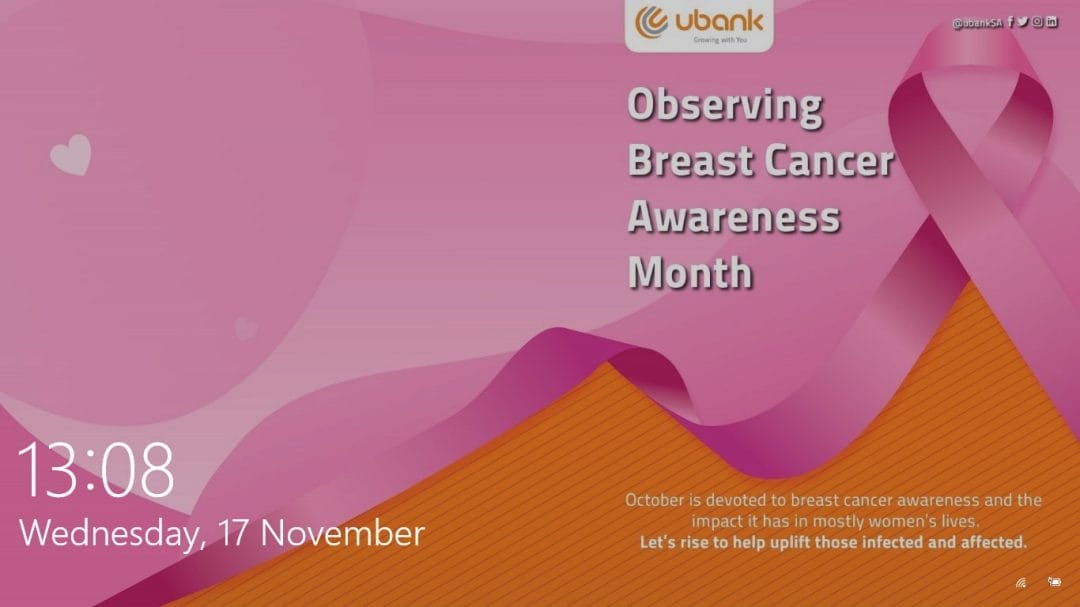 A digital poster features pink ribbons for Breast Cancer Awareness, the ubank logo, and text promoting Breast Cancer Awareness Month. Leveraging corporate communications software, a short message encourages supporting affected women. The date and time display at the bottom left: "13:08, Wednesday, 17 November.