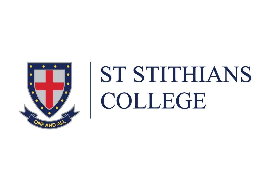 The St Stithians College logo features a blue shield containing a red cross and yellow dots, a banner reading “One and All,” and the college name in blue serif text to the right. Set against a white background, this emblem projects an image suitable for corporate voice clients seeking professionalism and tradition.